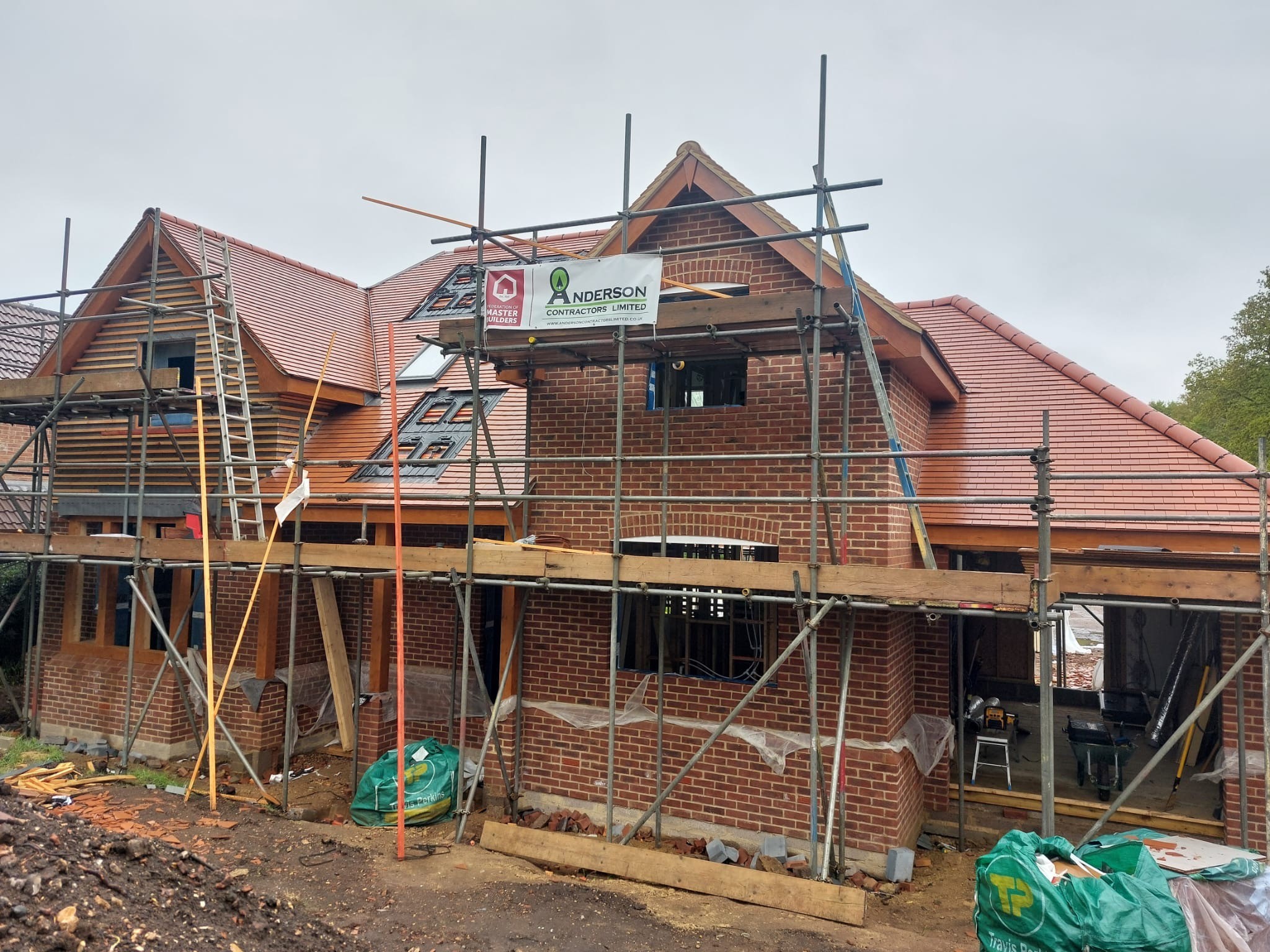 unit 1 completed brickwork Image of Geoff Anderson wearing a hi vis vest on a brownfield site